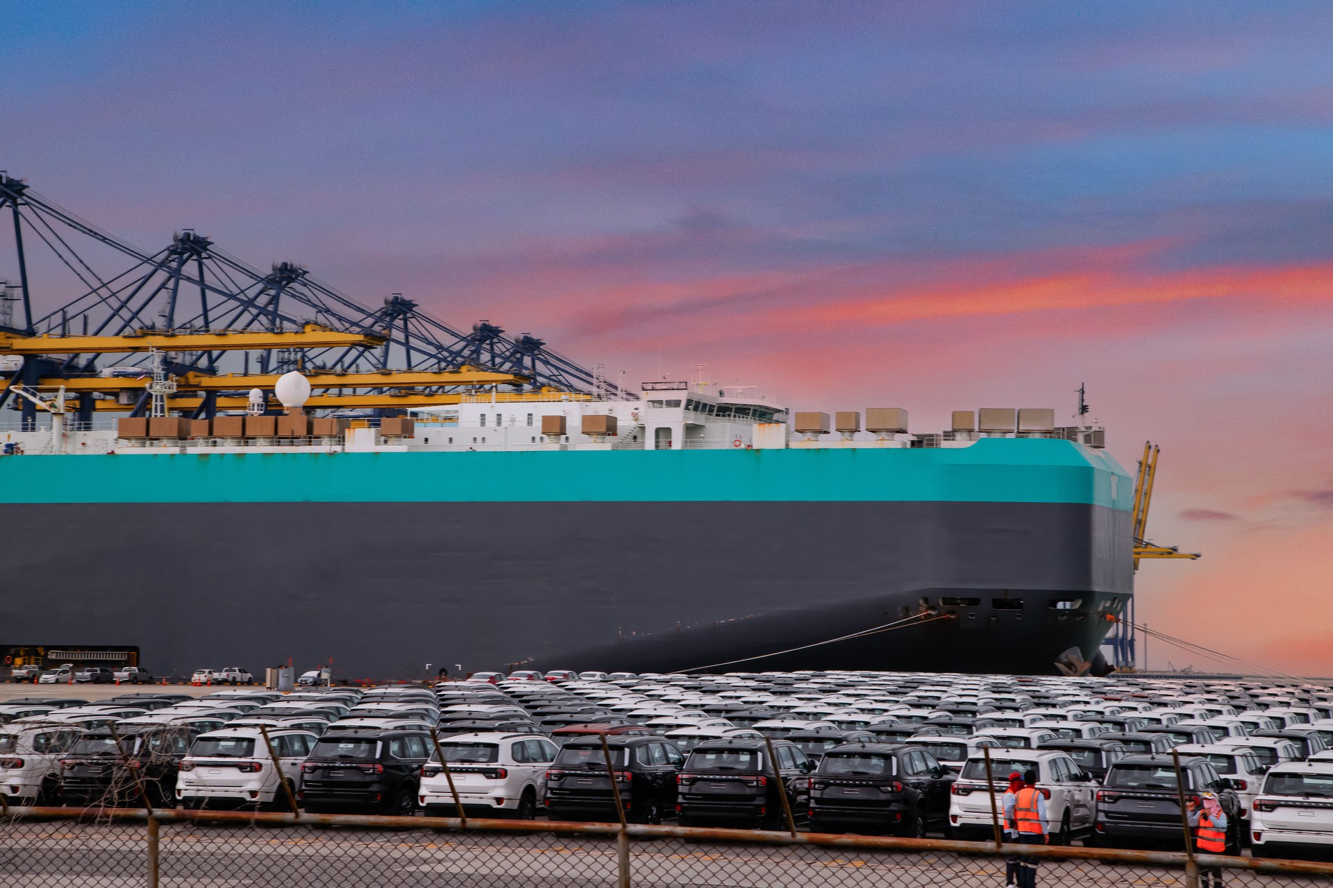 Close up vehicle carrier vessel loading car for shipping to worldwide, Large RoRo (Roll on off) vehicle car carrier, New car lined up in the port for import export around the world.